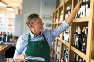 Portrait of sommelier taking inventory in wine store